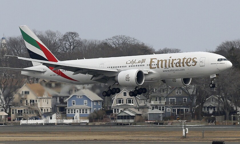 FILE - An Emirates Airlines Boeing 777 lands at Logan International Airport in Boston, March 10, 2014. Long-haul carrier Emirates said Thursday, Jan. 20, 2022, it would resume its Boeing 777 flights to the U.S. amid an ongoing dispute over the rollout of new 5G services there. (AP Photo/Michael Dwyer, File)