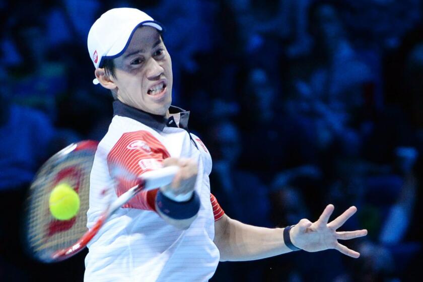 Kei Nishikori returns a shot during his victory over Andy Murray at the ATP Finals in London on Sunday.