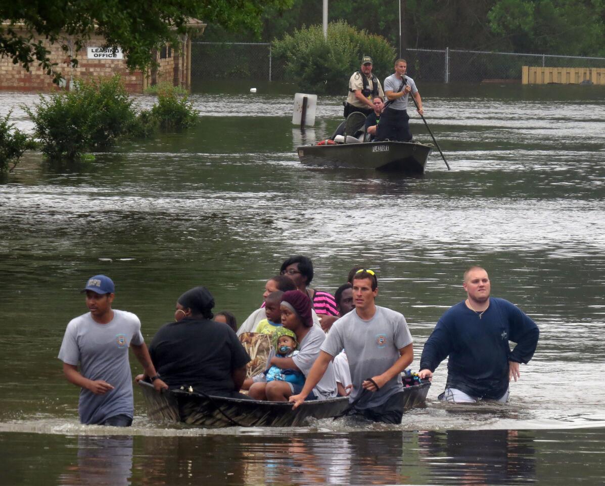 Residents at the Forest Creek Apartments in Pensacola, Fla., are rescued by boat after flooding.