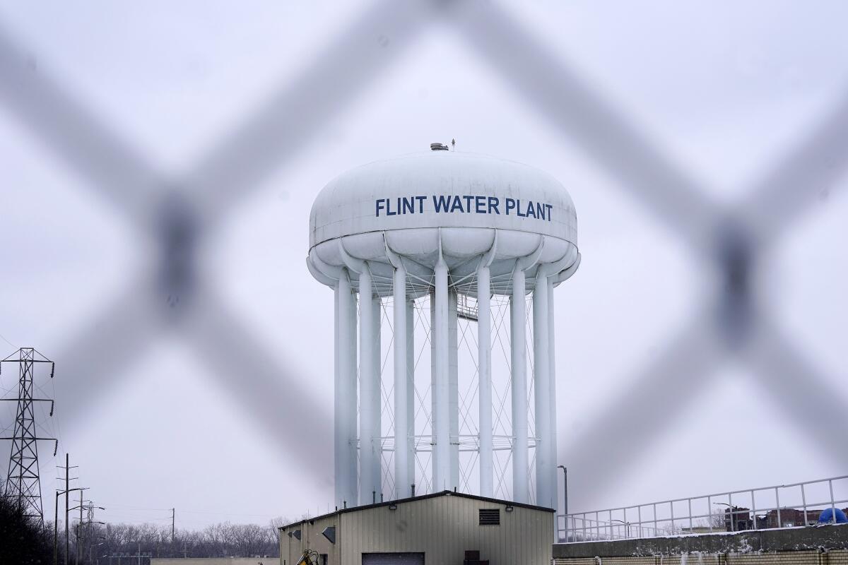 FILE - The Flint water plant tower is seen, Thursday, Jan. 6, 2022, in Flint, Mich. A Michigan Supreme Court order that charges related to the Flint water scandal against former Gov. Rick Snyder, his health director and seven other people must be dismissed is the latest development in the crisis that started in 2014. That was when the city began taking water from the Flint River without treating it properly, resulting in lead contamination. (AP Photo/Carlos Osorio, File)