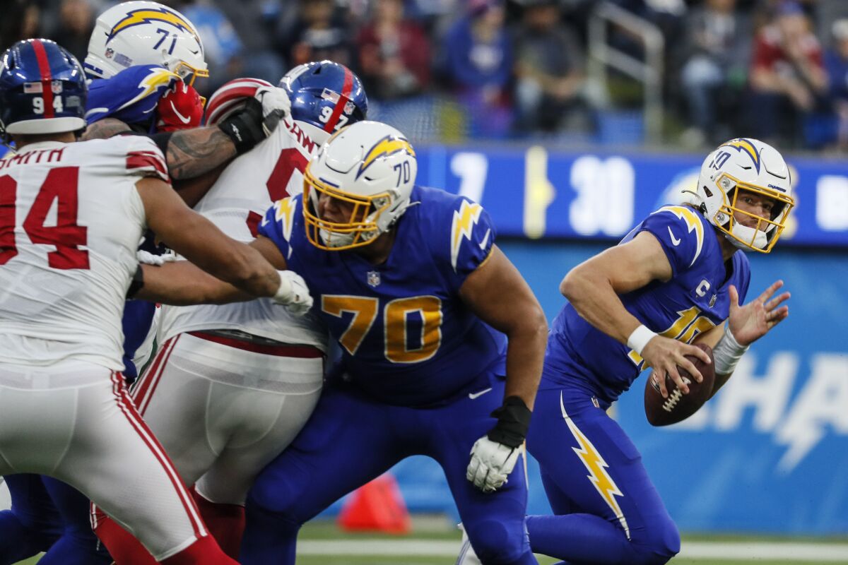 Chargers quarterback Justin Herbert rolls out of the pocket against the Giants.