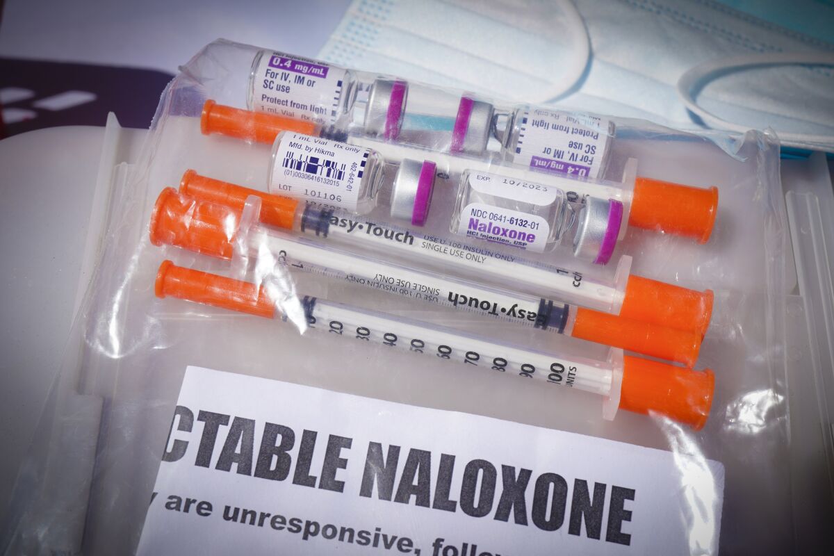 A plastic bag containing syringes and vials of injectable naloxone.