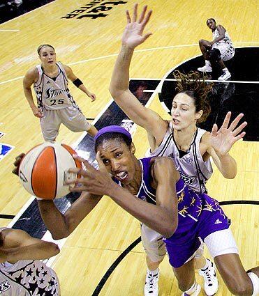 Los Angeles Sparks center Lisa Leslie shoots as San Antonio Silver Stars' Ruth Riley, right, defends during a Sept. 27 matchup in San Antonio. Basketball icon Leslie is expected to announce her retirement. Read more on The Times' Fabulous Forum blog.