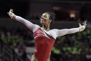 FILE - Gabrielle Douglas smiles after competing on the floor exercise during the women's U.S. Olympic gymnastics.
