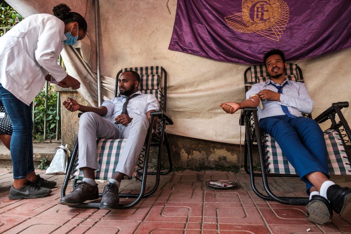  A nurse assists people while they donate blood in the city of Gondar, Ethiopia, Friday.