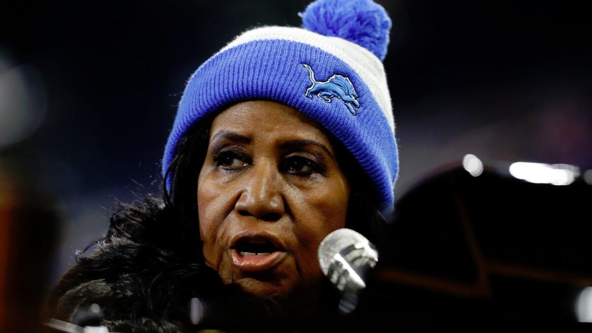 Aretha Franklin rehearses the national anthem during warmups of an NFL football game between the Detroit Lions and the Minnesota Vikings on Thursday, Nov. 24 in Detroit.