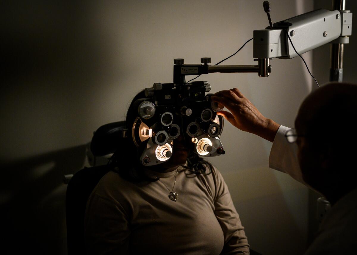 Mary Clarksenior gets an eye exam from Dr. Norman Denton.