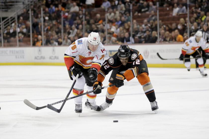 Devante Smith-Pelly competes for the puck with Calgary's Michael Ferland on Nov. 25.