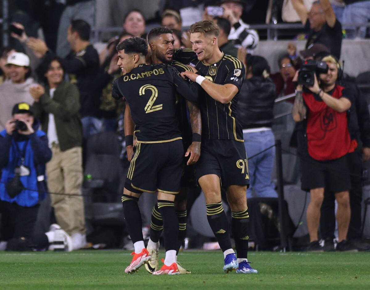 LAFC forward Denis Bouanga, center, celebrates with Omar Campos, left, and Luis Muller.