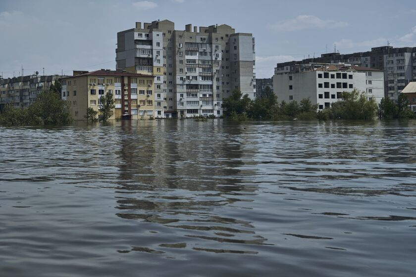 A view of a flooded neighborhood in Kherson, Ukraine, Thursday, June 8, 2023. Floodwaters from a collapsed dam kept rising in southern Ukraine on Thursday, forcing hundreds of people to flee their homes in a major emergency operation that brought a dramatic new dimension to the war with Russia, now in its 16th month. (AP Photo/Libkos)