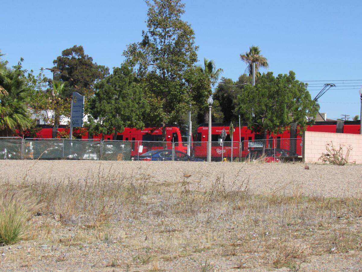 The San Diego Trolley goes by the long-empty lot that will soon become a 147-unit affordable apartment complex in La Mesa.