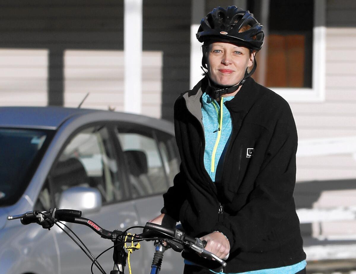 Nurse Kaci Hickox leaves her home on a rural road in Fort Kent, Maine, on Thursday to take a bike ride in defiance of a quarantine.