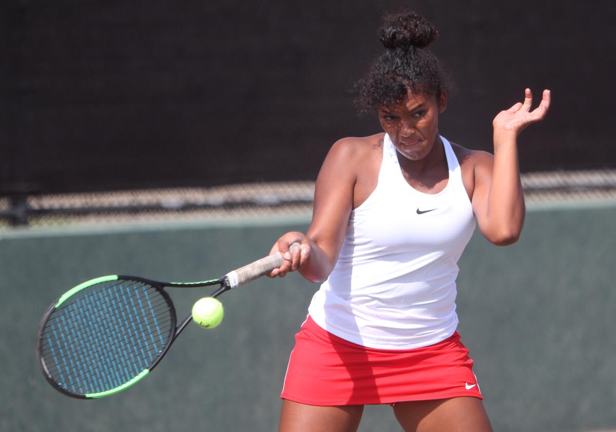Burroughs High School girls' singles player Isabella Harris-Bermudez returns the serve in home match vs. Glendale High School in Burbank, on Tuesday, Sept. 10, 2019.