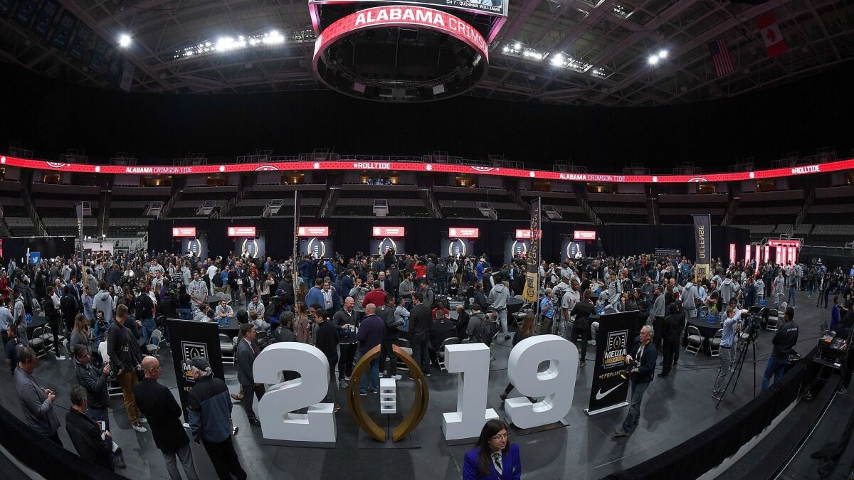 Coaches and players of the Alabama Crimson Tide are interviewed in SAP Center in San Jose during media day for the College Football Playoff championship game.
