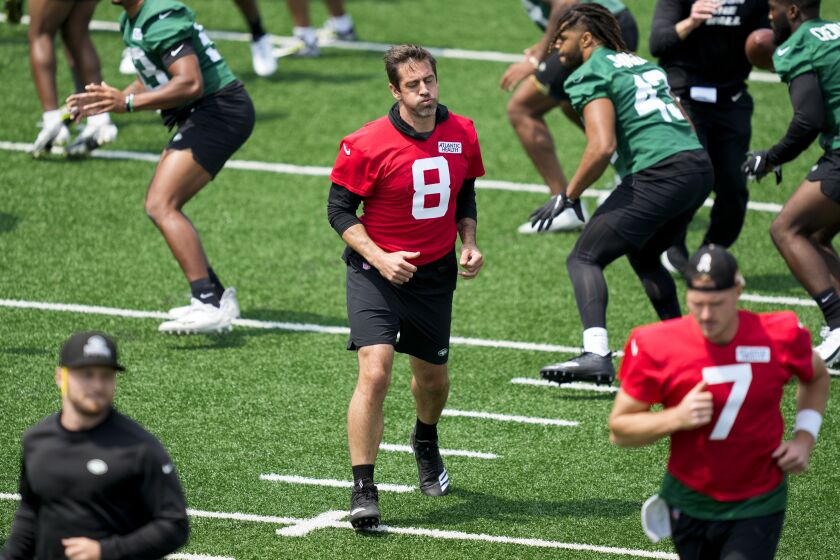 New York Jets quarterback Aaron Rodgers performs stretching drills with his teammates at the NFL football team's practice facility, Tuesday, May 23, 2023, in Florham Park, N.J. (AP Photo/John Minchillo)