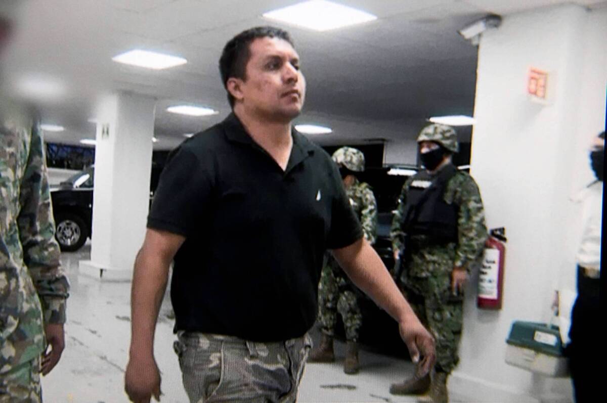 In Mexico City, Miguel Angel Treviño Morales, head of the Zetas paramilitary gang, is escorted by marines upon his arrival at the headquarters of the top body for prosecuting organized crime, in an image taken from video.