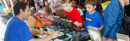 Author Derek Taylor Kent (left) signs books for fans at the Children's Pavilion.
