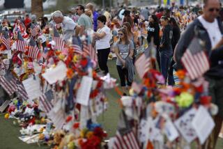 FILE - People visit a makeshift memorial honoring the victims of the Oct. 1, 2017, mass shooting in Las Vegas, on Nov. 12, 2017. Five years after a gunman killed 58 people and wounded hundreds more at a country music festival in Las Vegas, in the deadliest mass shooting in modern U.S. history, the massacre is now part of a horrifying increase in the number of mass slayings with more than 20 victims, according to a database of mass killings maintained by The Associated Press, USA Today and Northeastern University. (AP Photo/John Locher, File)