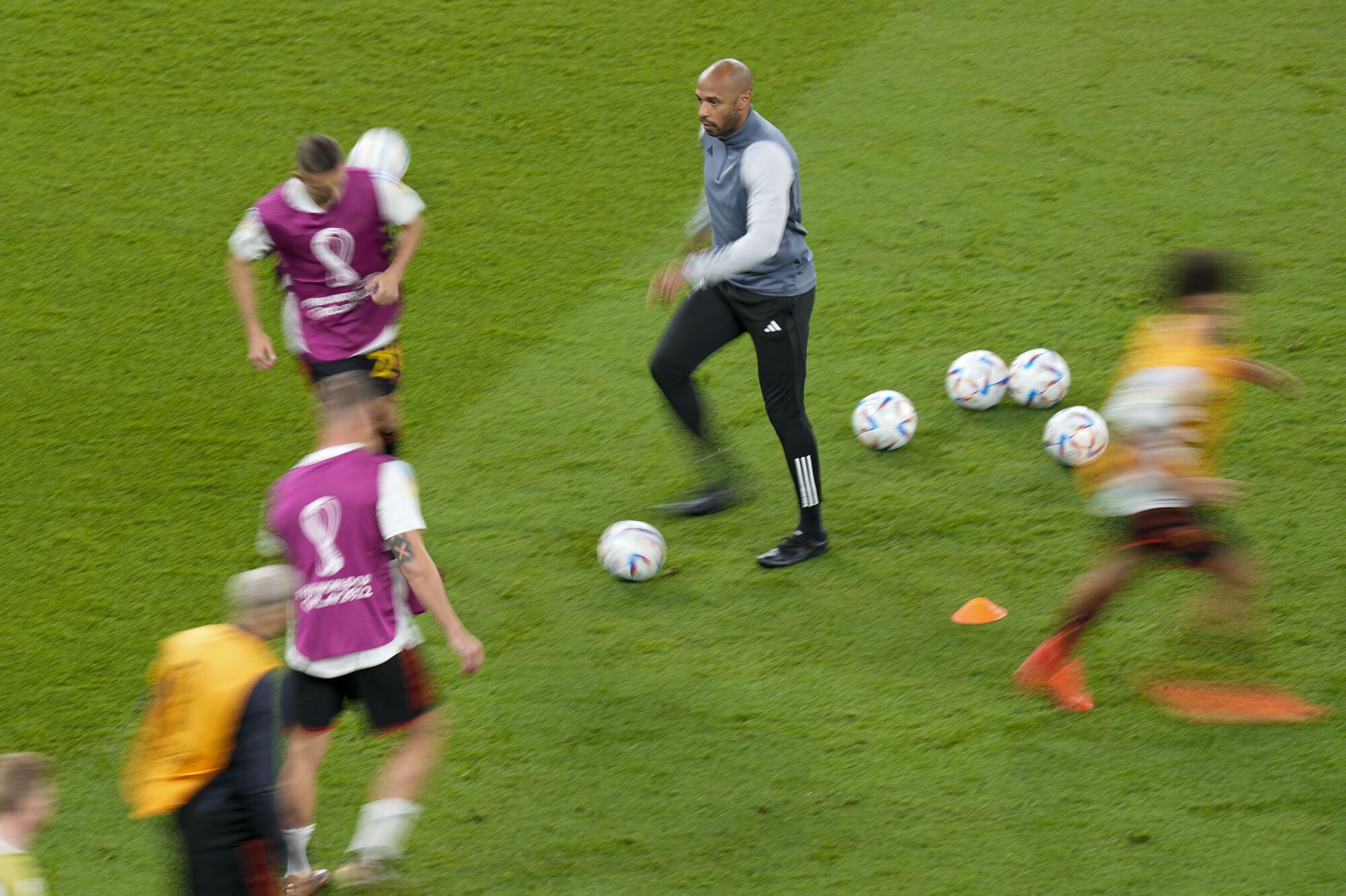 Belgium assistant coach Thierry Henry watches during warmups before the World Cup match between Belgium and Canada.