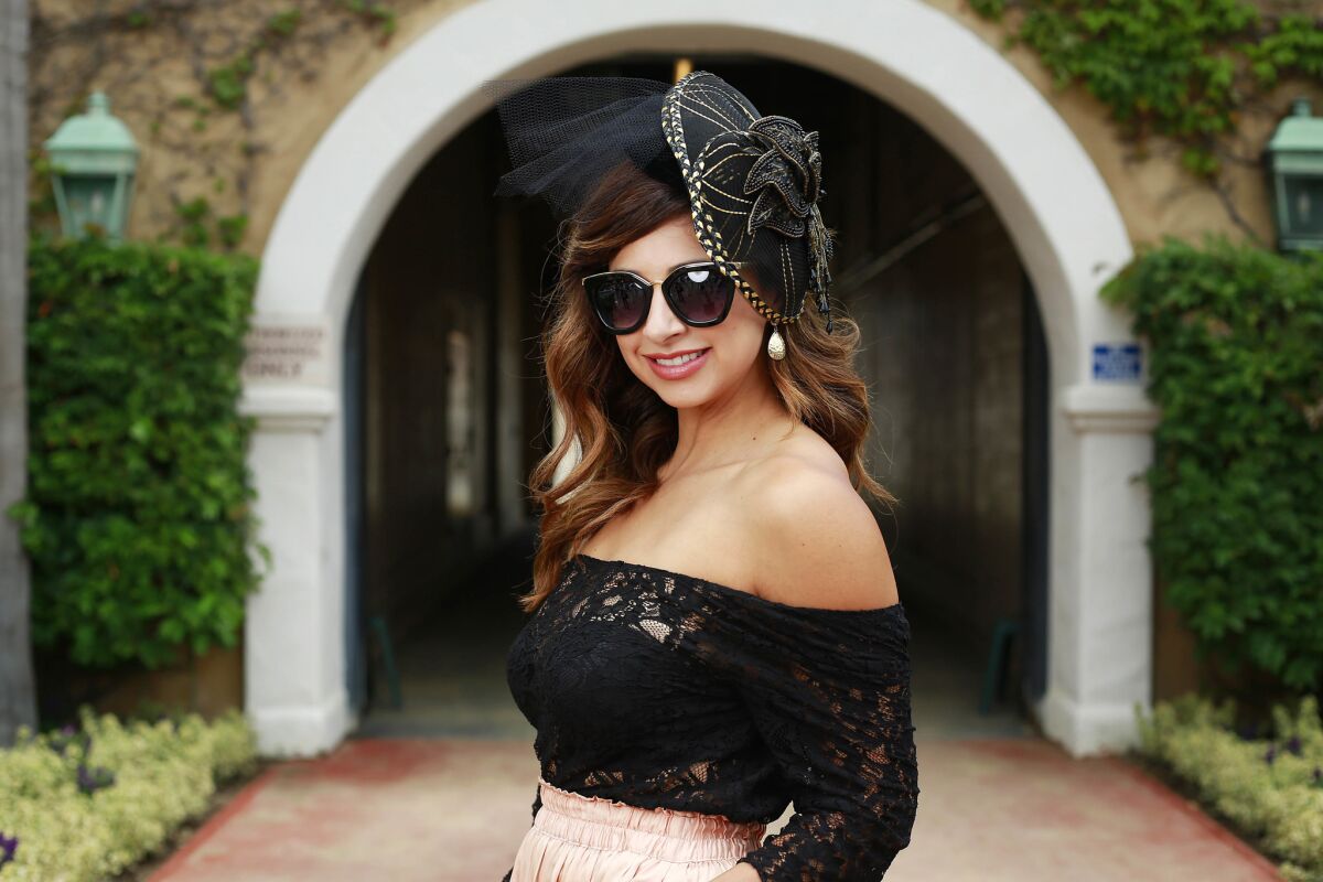 Victoria Vega shows off her hat on Opening Day at the Del Mar Thoroughbred Club on July 19, 2017.