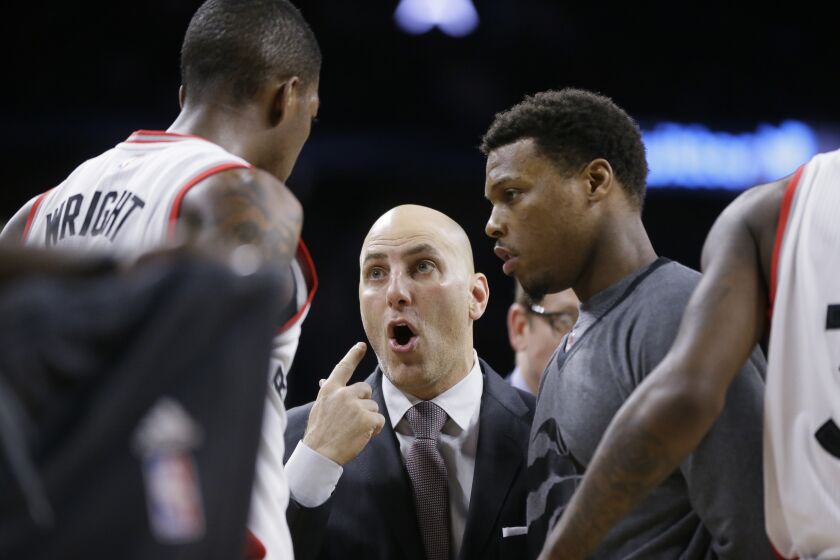 Toronto Raptors assistant coach Rex Kalamian talks with guard Delon Wright (55) during the first half of an NBA basketball game against the Detroit Pistons, Sunday, Feb. 28, 2016, in Auburn Hills, Mich. (AP Photo/Carlos Osorio)