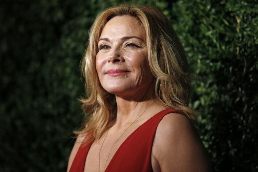 (FILES) In this file photo taken on November 30, 2014 British-Canadian actress Kim Cattrall poses on the red carpet as she attends the 60th London Evening Standard Theatre Awards. Appeals by "Sex and the City" actress Kim Cattrall for help in finding her missing brother ended in sadness on February 4, 2018, when she announced his death. "It is with great sadness that myself and my family announce the unexpected passing of our son and brother, Chris Cattrall," she said in a tweet, less than 24 hours after publicly appealing for help in finding him. / AFP PHOTO / Justin TALLISJUSTIN TALLIS/AFP/Getty Images ** OUTS - ELSENT, FPG, CM - OUTS * NM, PH, VA if sourced by CT, LA or MoD **