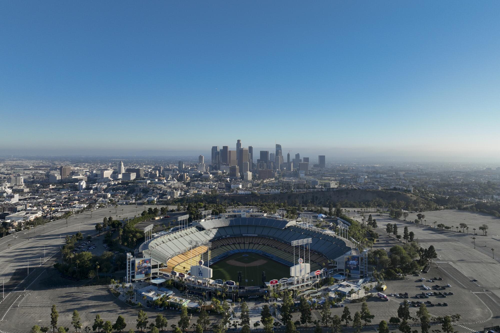 An aerial view of Dodger Stadium with downtown L.A. in the background.