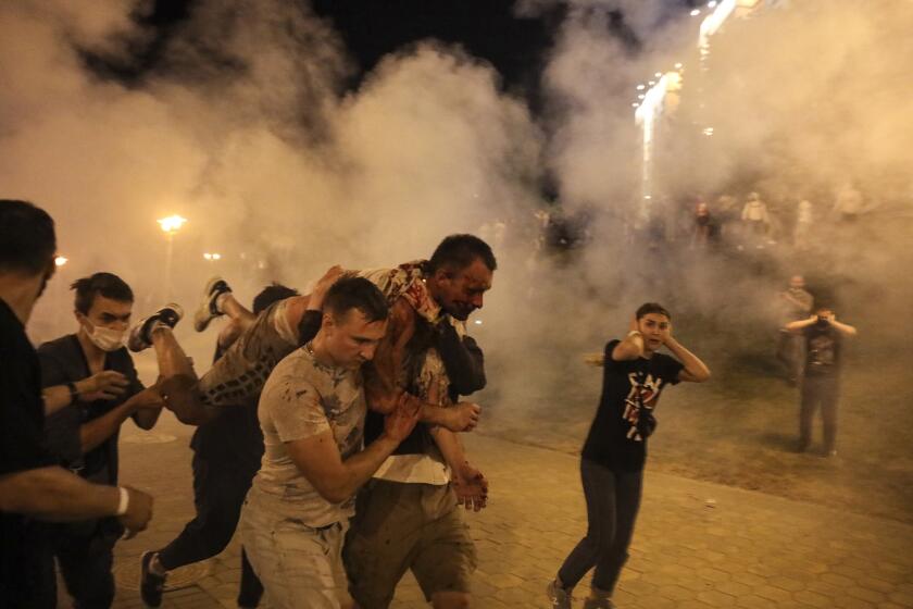 Protesters carry a wounded man during clashes with police after the presidential election in Minsk, Belarus, early Monday, Aug. 10, 2020. Police and protesters clashed in Belarus' capital and the major city of Brest on Sunday after the presidential election in which the authoritarian leader who has ruled for a quarter-century sought a sixth term in office. (AP Photo)