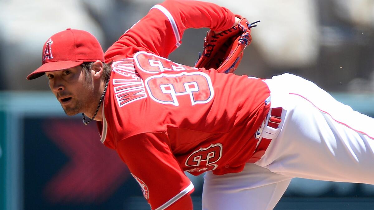 Angels starter C.J. Wilson, shown in a July 9 game, was pleased with the velocity of his fastball and his mechanics during a rehabilitation start with double-A Arkansas on Monday.