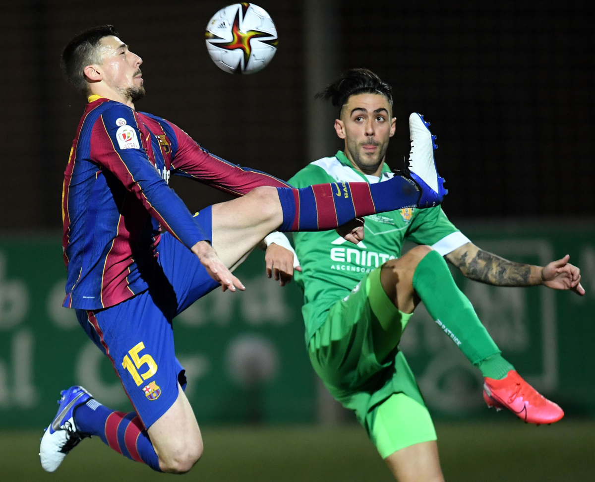 Barcelona's Clement Lenglet battles for possession with Albert Manel Estelles Fernandez of Cornellà.