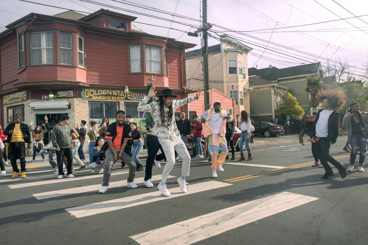 A group of people dancing in a crosswalk in Oakland