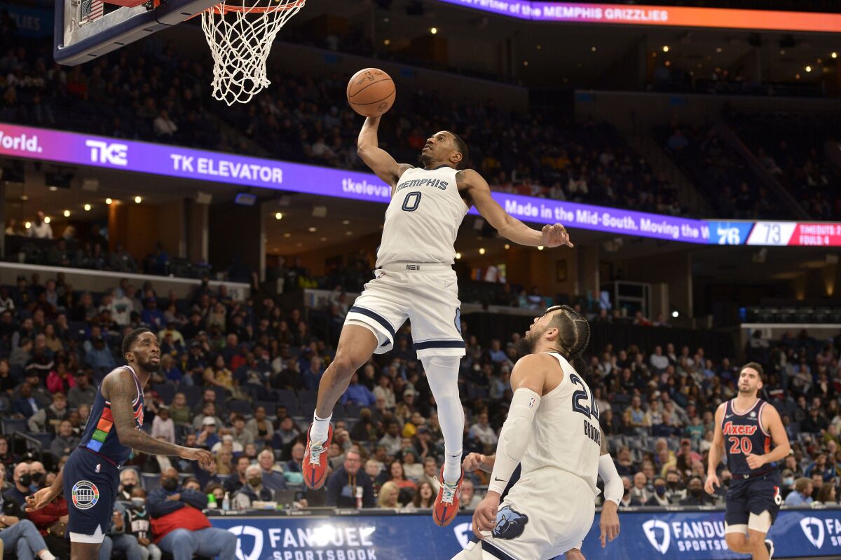 Memphis Grizzlies guard De'Anthony Melton (0) goes up for a dunk in the second half of an NBA basketball game against the Philadelphia 76ers, Monday, Dec. 13, 2021, in Memphis, Tenn. (AP Photo/Brandon Dill)