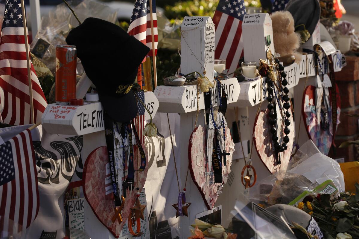 Crosses bear the names of the victims of the Borderline shooting at the growing memorial at Moorpark Road and West Rolling Oaks Drive in Thousand Oaks near the Borderline Bar & Grill.