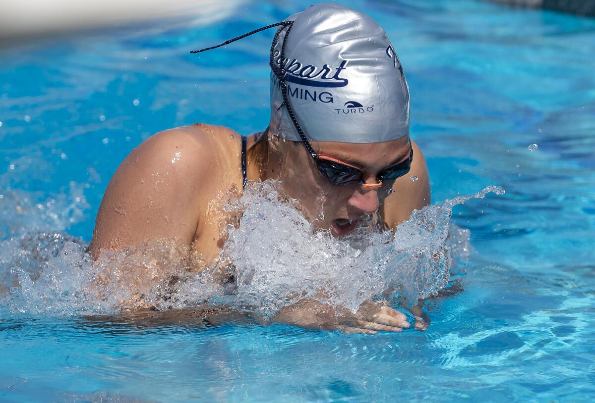 Newport Harbor's Mia Abourjeily swims breaststroke in the 200 medley relay during the annual Battle of the Bay on Tuesday.
