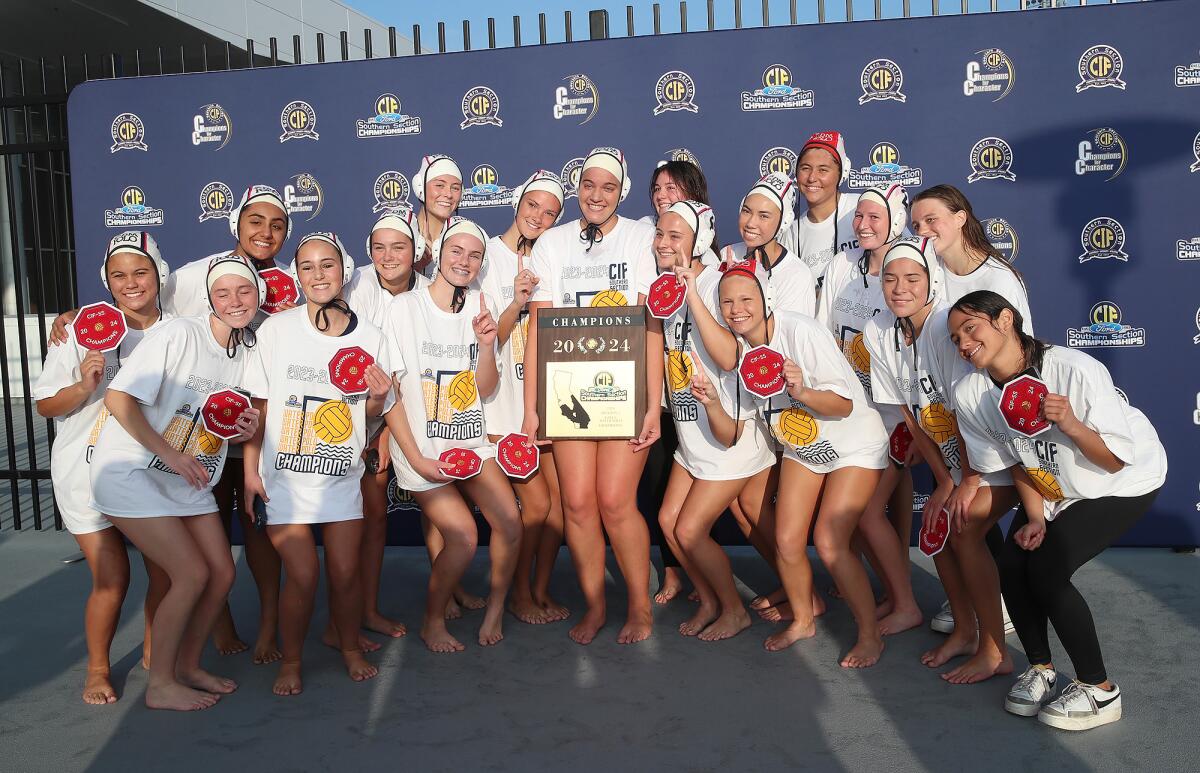 The Corona del Mar girls' water polo team poses for a picture after winning the CIF Southern Section, Division 1 title.