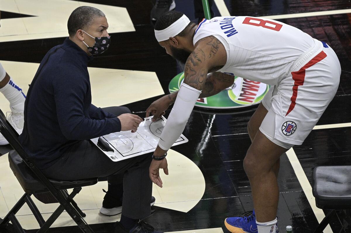Clippers coach Tyronn Lue and forward Marcus Morris discuss a play during a timeout.