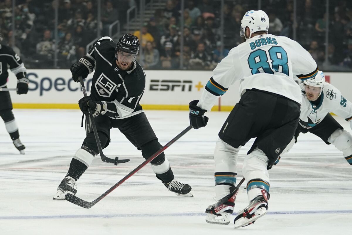 Los Angeles Kings center Anze Kopitar (11) shoots against San Jose Sharks defenseman Brent Burns (88) during the second period of an NHL hockey game Thursday, March 17, 2022, in Los Angeles. (AP Photo/Ashley Landis)