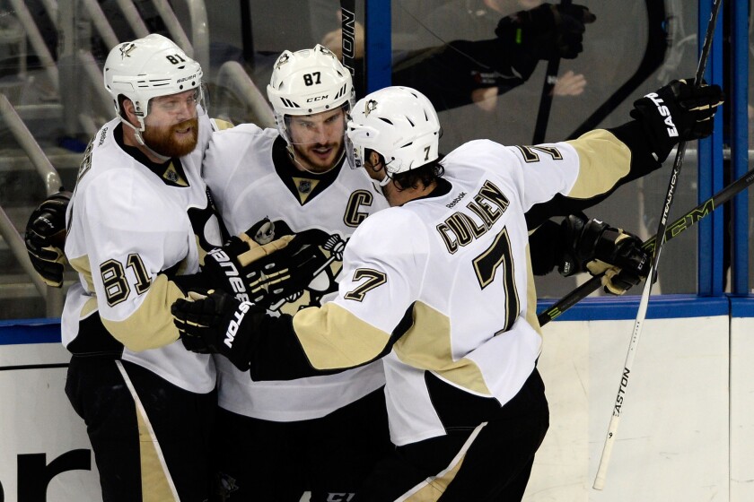 Pittsburgh Penguins' Sidney Crosby, center, celebrates with his teammates Phil Kessel, left, and Matt Cullen after scoring a goal against the Tampa Bay Lightning during the second period in Game 6 of the Stanley Cup Eastern Conference Final on Tuesday.