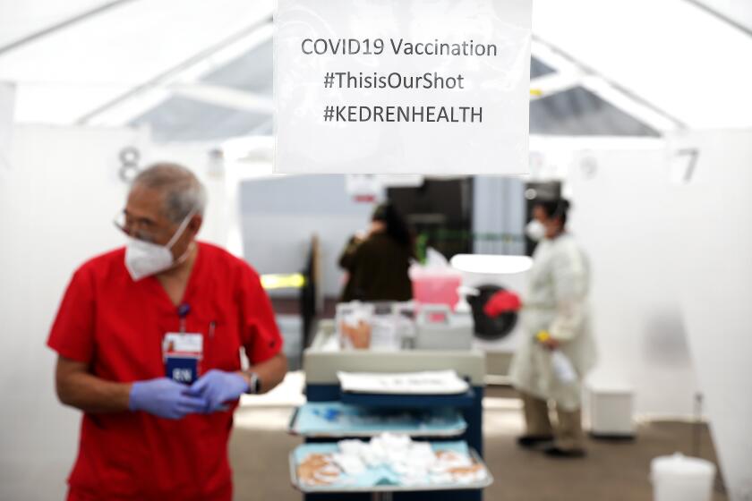 LOS ANGELES-CA-MARCH 22, 2021: People line up to be vaccinated at Kedren Community Health Center in South Los Angeles on Monday, March 22, 2021. (Christina House / Los Angeles Times)