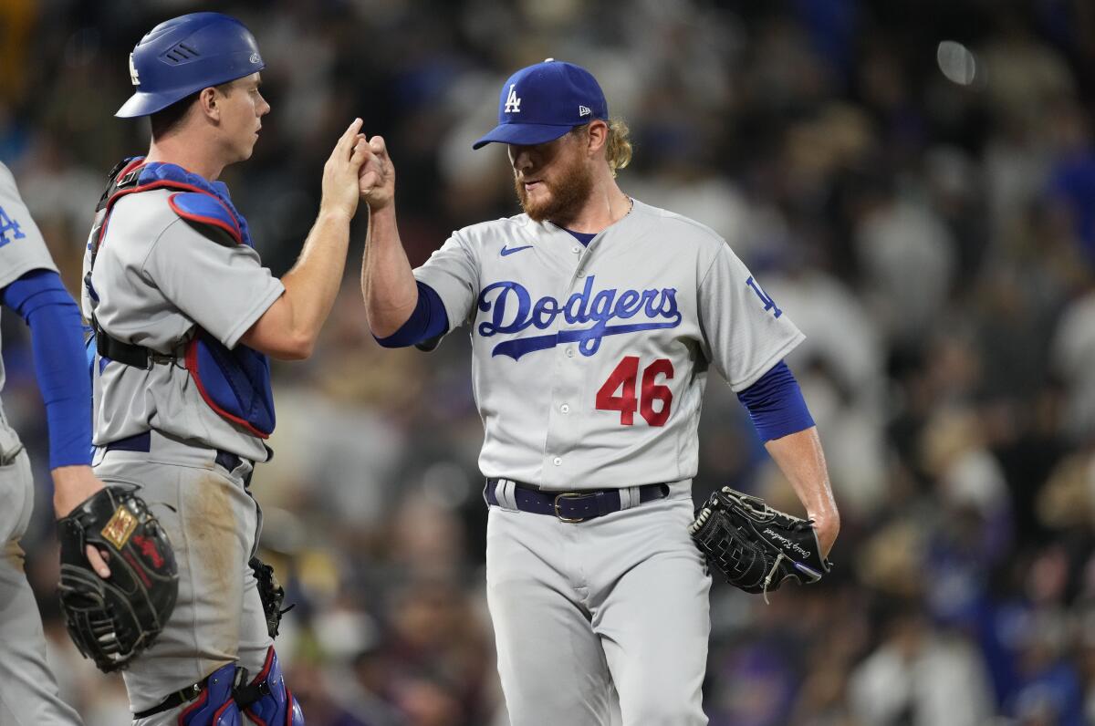 Dodgers reliever Craig Kimbrel celebrates with catcher Will Smith after a 5-4 win over the Colorado Rockies at Coors Field.