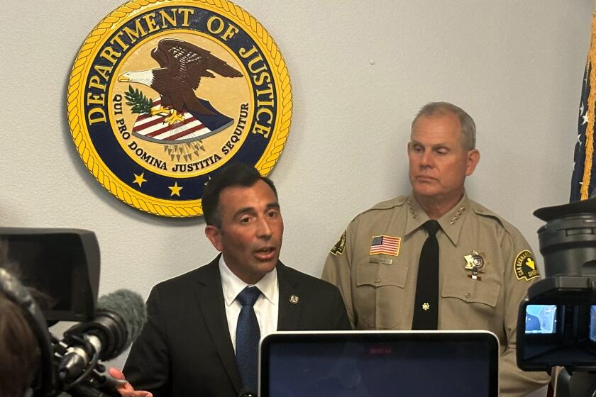 United States Attorney Martin Estrada, accompanied by San Bernardino County Sheriff Shannon Dicus and ATF Assistant Special Agent in Charge Jose Pedro, addresses the media in Riverside, California, to discuss federal criminal charges against a man who assaulted a sheriff's deputy (US Attorney Central District of California)