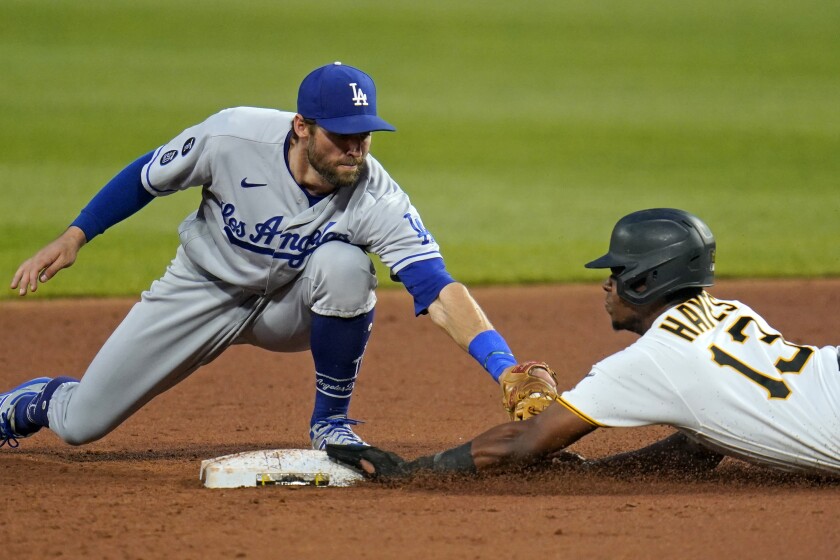 Los Angeles Dodgers second baseman Chris Taylor, left, tags Pittsburgh Pirates' Ke'Bryan Hayes (13) during the third inning 