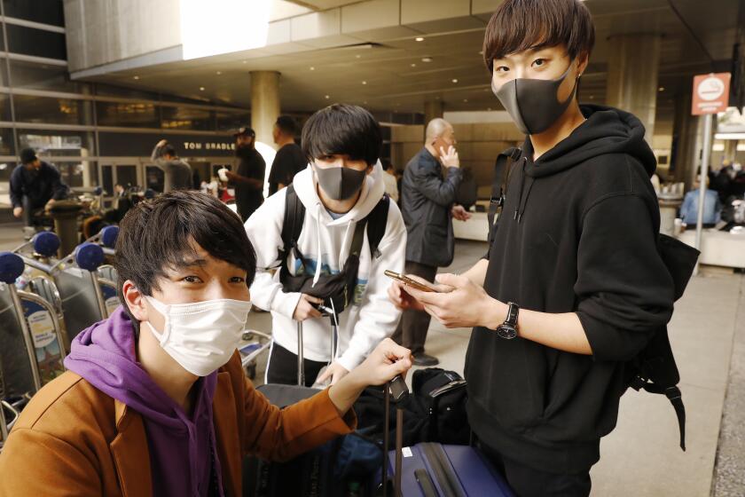 Yamaguchi Kazuya, from left, Shirai Wataru and Kohnosuke Takemoto at the Tom Bradley International Terminal in 2020.