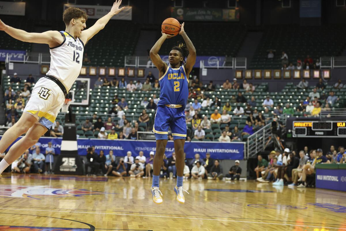 UCLA's Dylan Andrews shoots over a Marquette player.