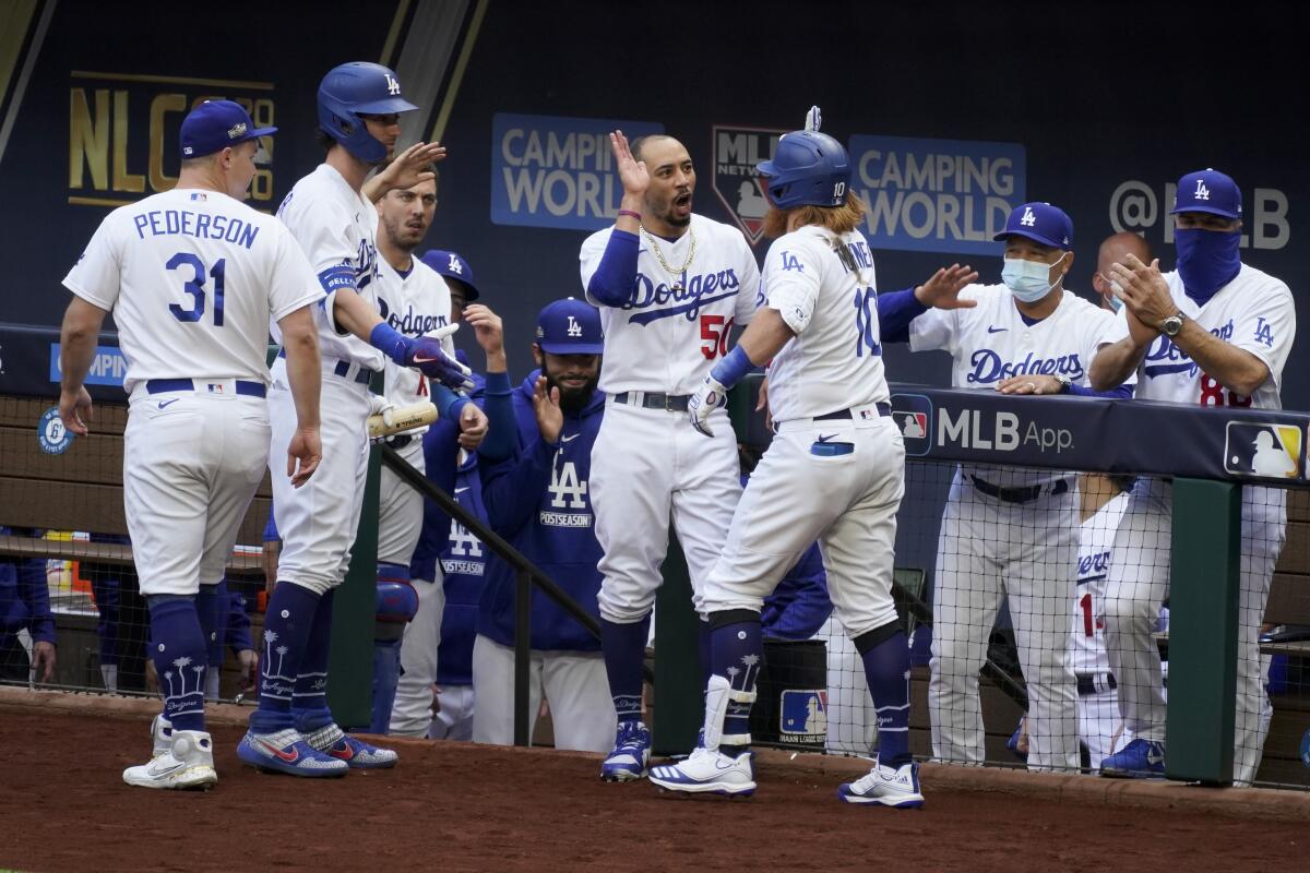 Dodgers third baseman Justin Turner, center, celebrates with teammates after hitting a home run in the first inning.