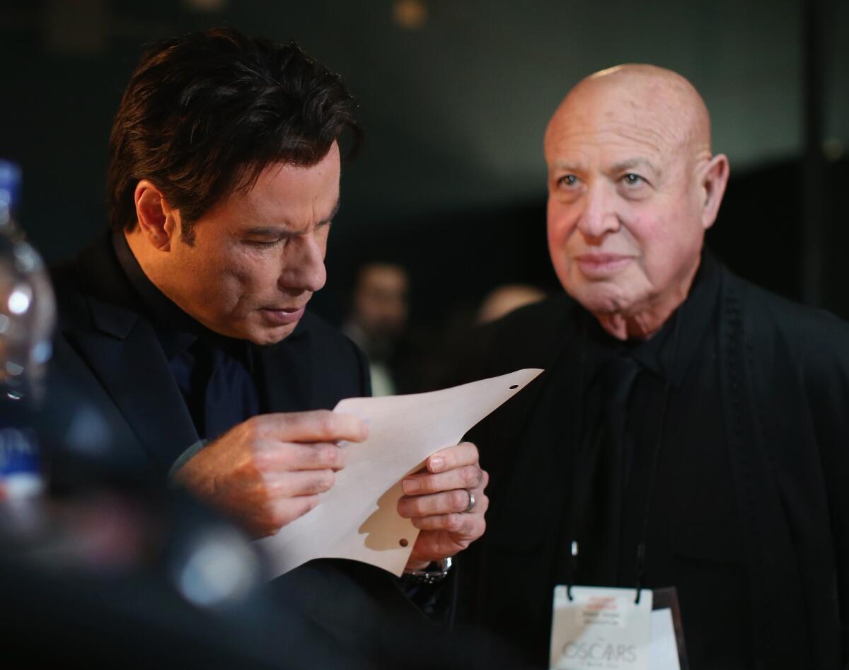 Actor John Travolta and publicist Paul Bloch are shown backstage at the 86th Oscars.