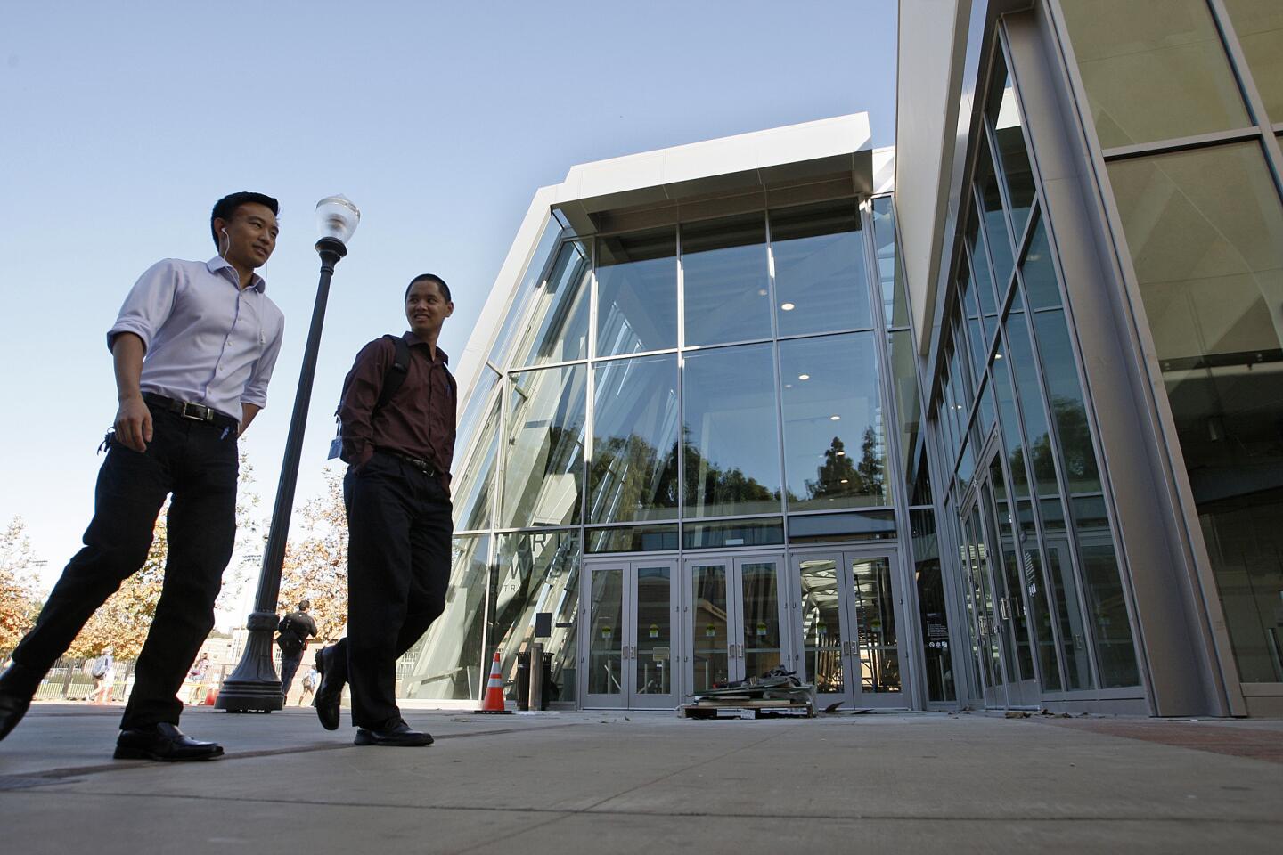 Students walk past an entrance to the freshly renovated Pauley Pavilion on the UCLA campus.