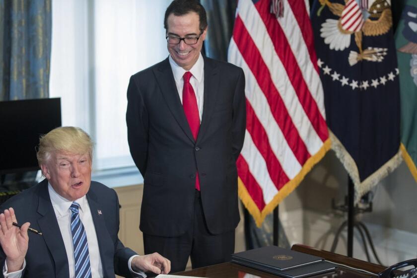 epa05920165 US President Donald J. Trump (L), with Secretary of Treasury Steven Mnuchin (R), participates in a financial services Executive Order signing ceremony in the US Treasury Department building in Washington, DC, USA, 21 April 2017. President Trump is making his first visit to the Treasury Department for a memorandum signing ceremony with Secretary Mnuchin. EPA/SHAWN THEW ** Usable by LA, CT and MoD ONLY **