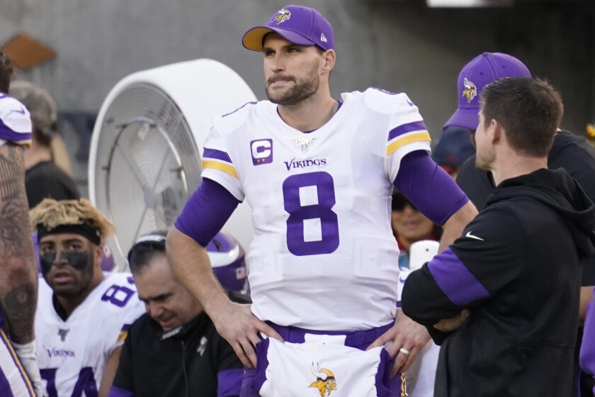 Minnesota Vikings quarterback Kirk Cousins stands on the sideline