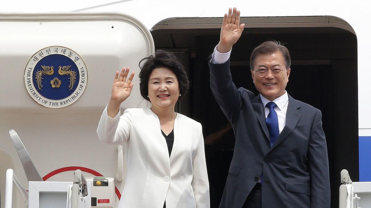 South Korean President Moon Jae-in and his wife Kim Jung-sook wave before leaving for the United States at the Seoul military airport in Seongnam, South Korea, Wednesday, June 28, 2017.